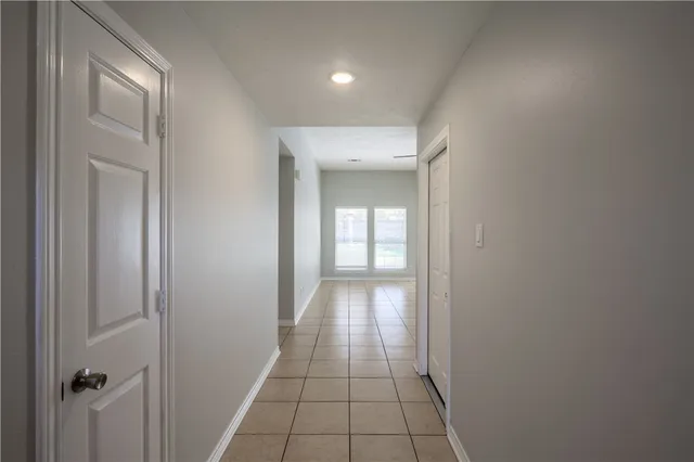 a view of an empty room with window and fireplace