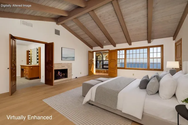 a spacious bedroom with a large bed and a large window