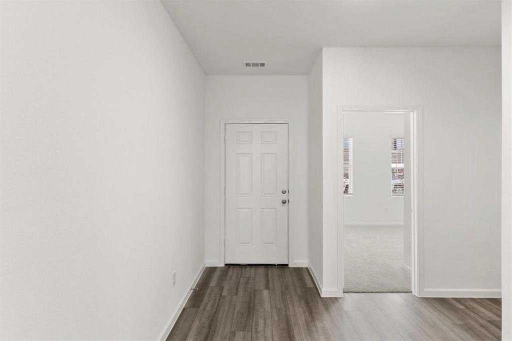 10308 Holy Cross Lane Crowley, TX 76036 - Photo 3 of 27 a view of a hallway with wooden floor