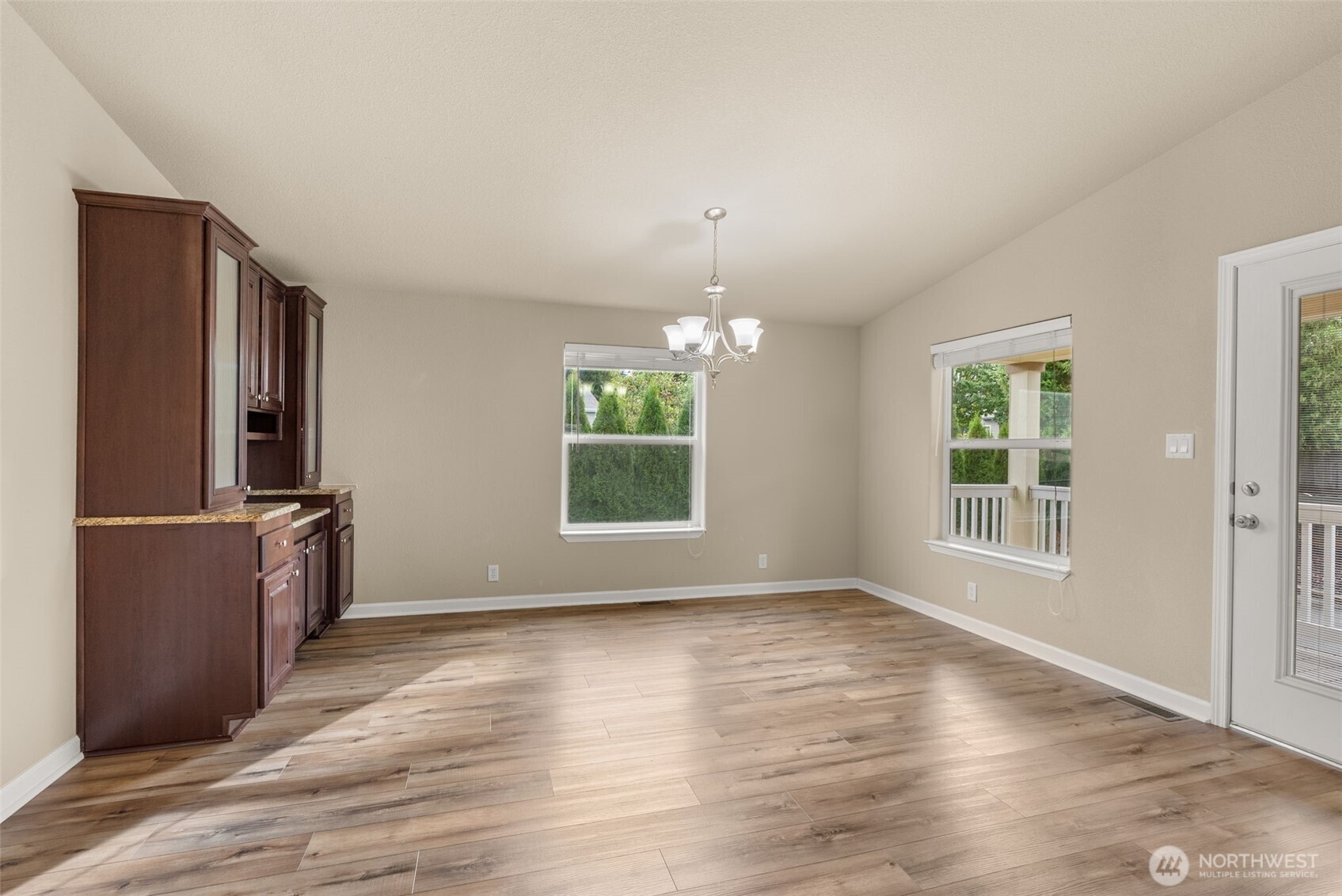 4259 Lakeview Lane Southeast, Unit 63 Lacey, WA 98503 - Photo 11 of 29 an empty room with wooden floor windows and cabinet