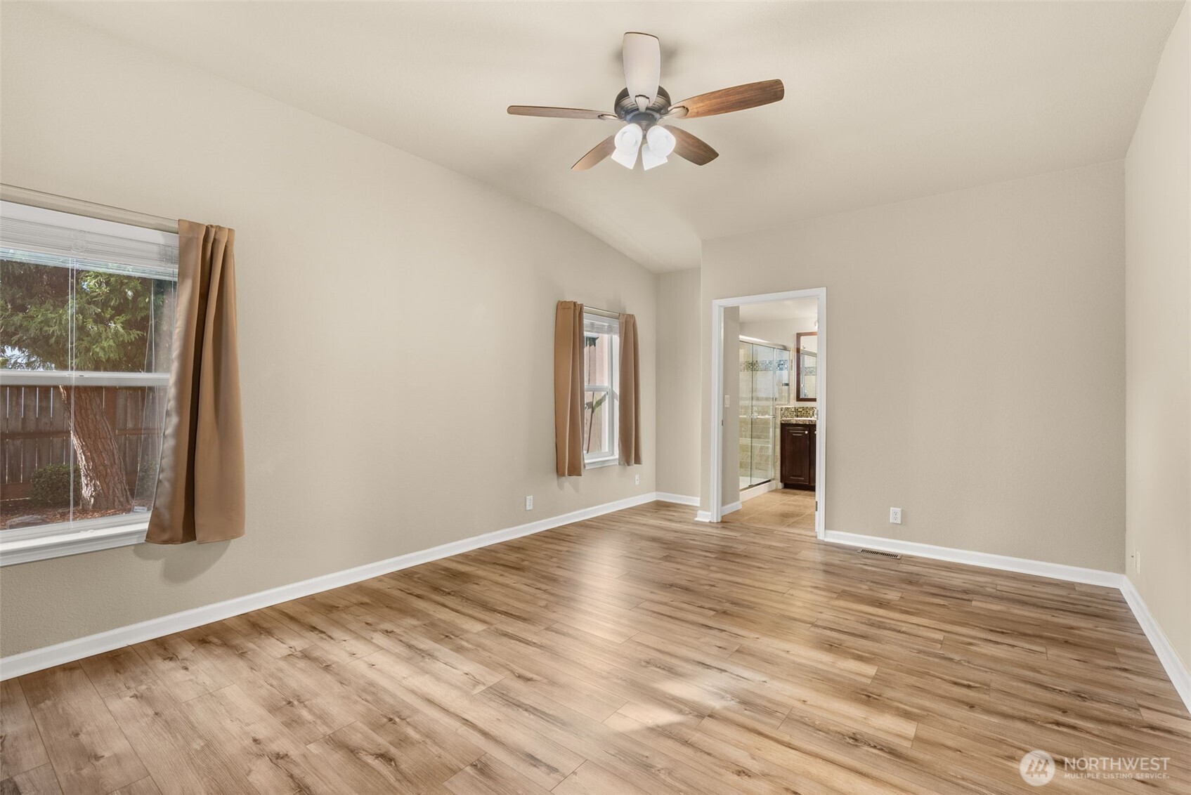 4259 Lakeview Lane Southeast, Unit 63 Lacey, WA 98503 - Photo 13 of 29 a view of an empty room with a window and wooden floor