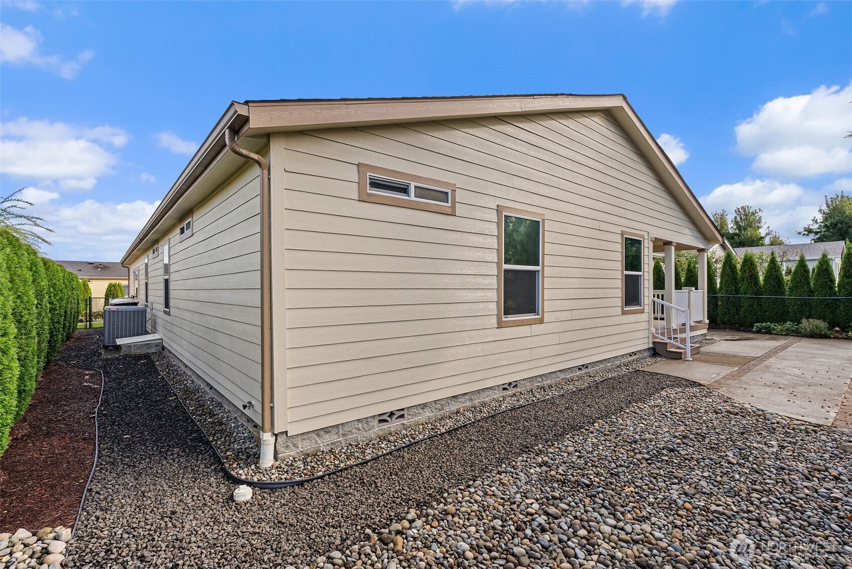 4259 Lakeview Lane Southeast, Unit 63 Lacey, WA 98503 - Photo 29 of 29 a view of a small white house with a small yard and a large window