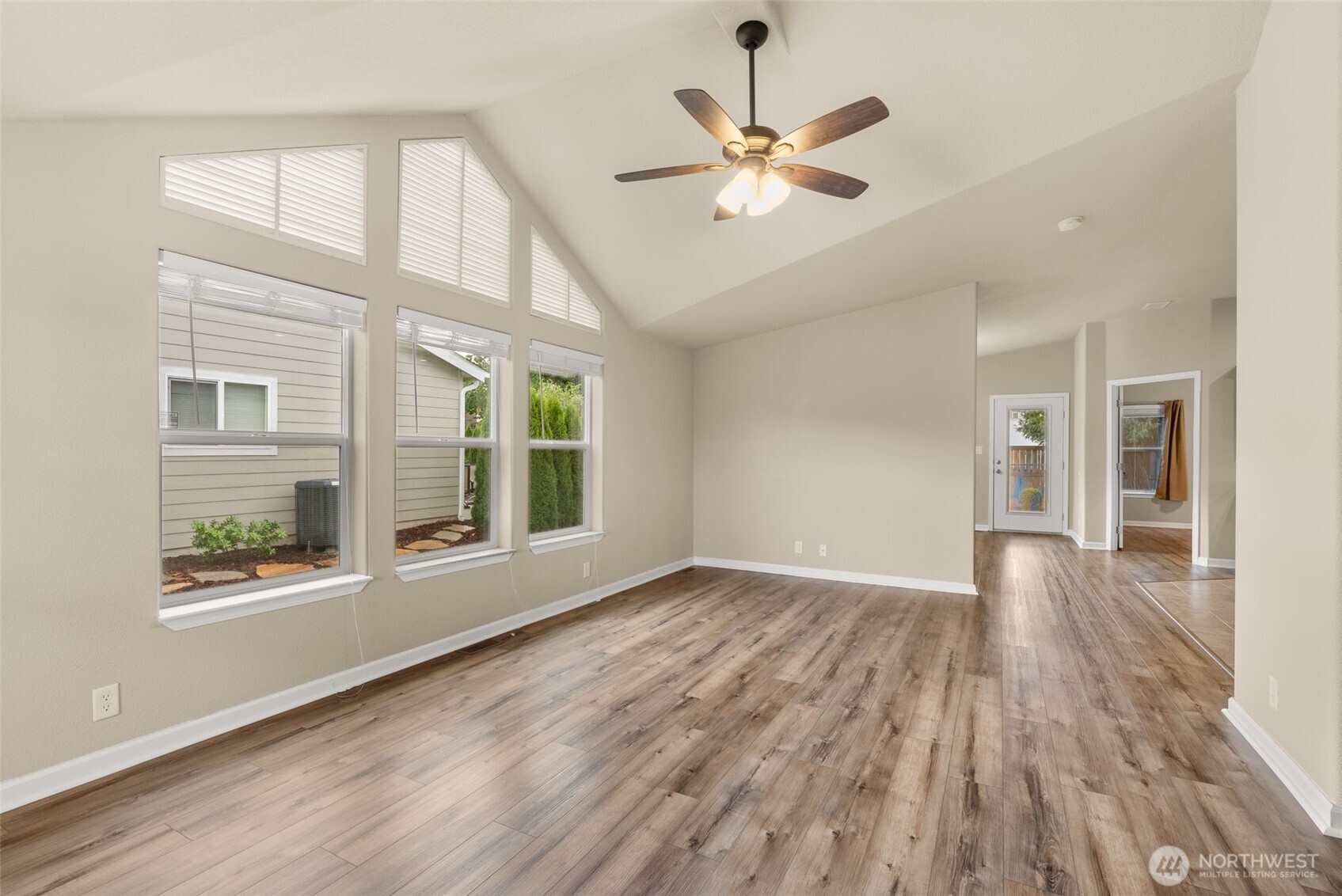 4259 Lakeview Lane Southeast, Unit 63 Lacey, WA 98503 - Photo 5 of 29 a view of an empty room with wooden floor and a window