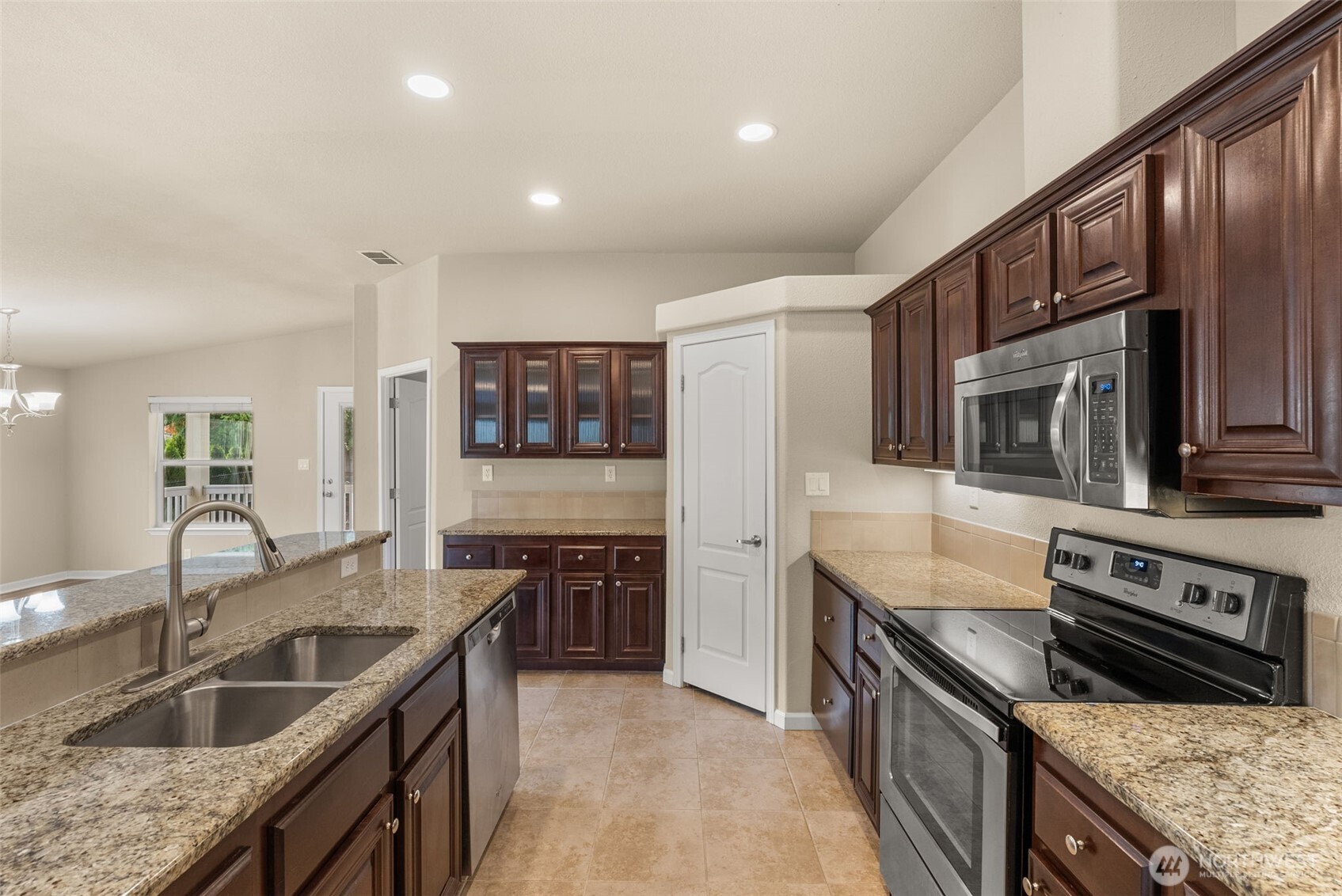 4259 Lakeview Lane Southeast, Unit 63 Lacey, WA 98503 - Photo 8 of 29 a kitchen with stainless steel appliances granite countertop a sink stove and refrigerator