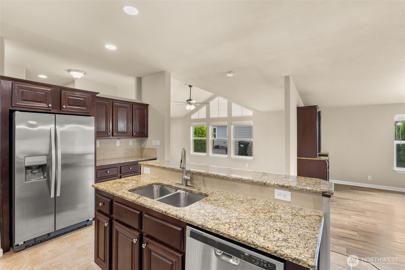 4259 Lakeview Lane Southeast, Unit 63 Lacey, WA 98503 - Photo 10 of 29 a kitchen with stainless steel appliances granite countertop a sink and a refrigerator