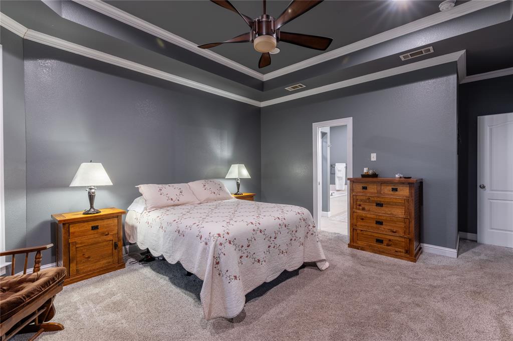 320 Rustic Oaks Road Combine, TX 75159 - Photo 24 of 40 Bedroom featuring carpet, crown molding, a raised ceiling, and ceiling fan