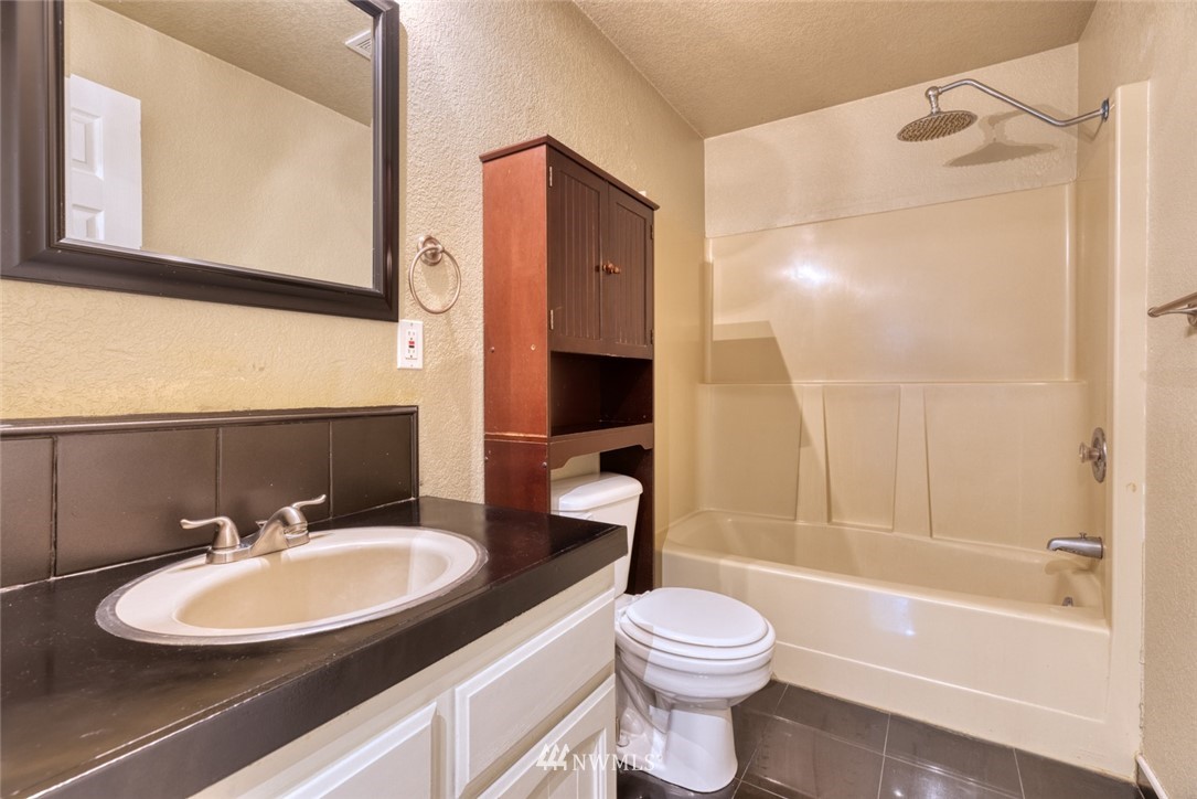 17517 48th Street East Lake Tapps, WA 98391 - Photo 16 of 36 a bathroom with a sink a toilet and a bathtub