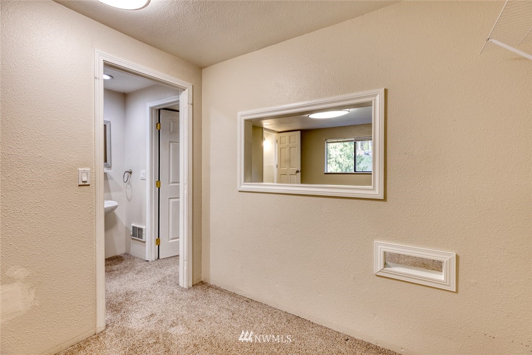 17517 48th Street East Lake Tapps, WA 98391 - Photo 24 of 36 a view of a hallway with wooden floor and a bathroom