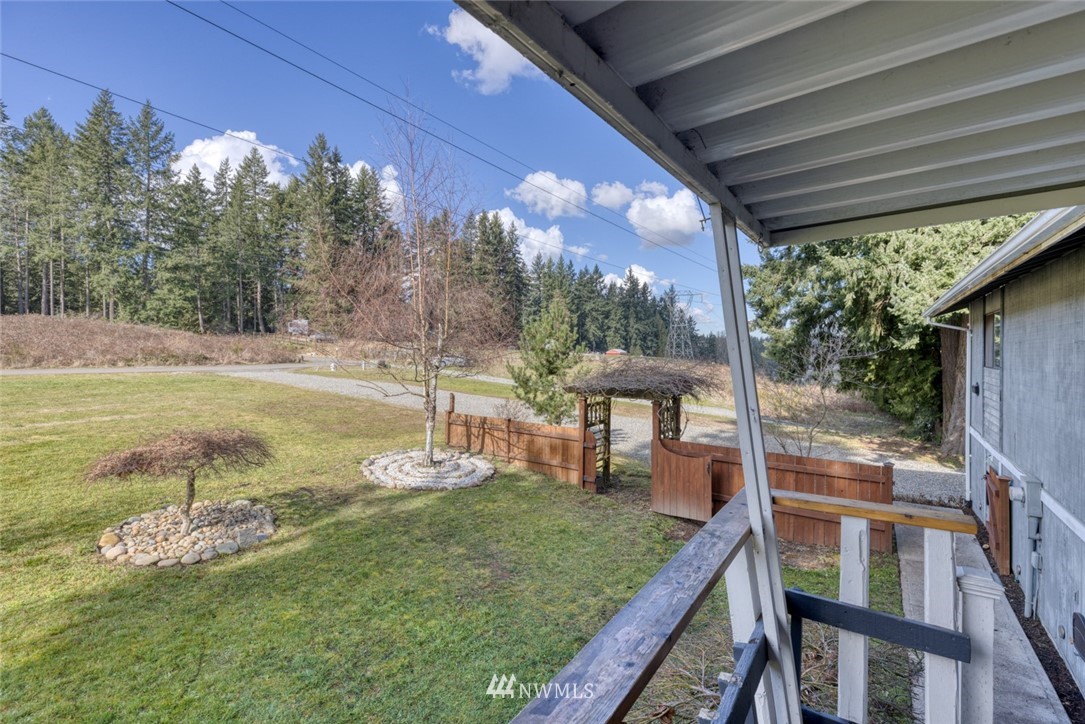 17517 48th Street East Lake Tapps, WA 98391 - Photo 34 of 36 a view of a porch with furniture and a yard