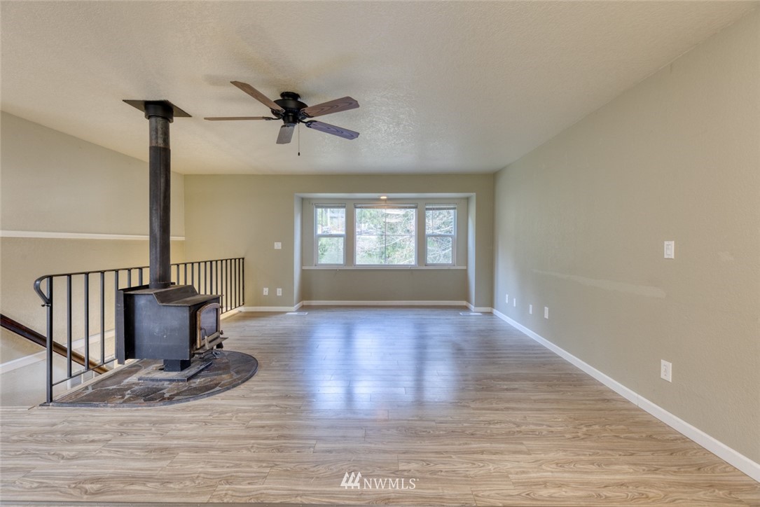 17517 48th Street East Lake Tapps, WA 98391 - Photo 6 of 36 a view of an empty room with window and wooden floor