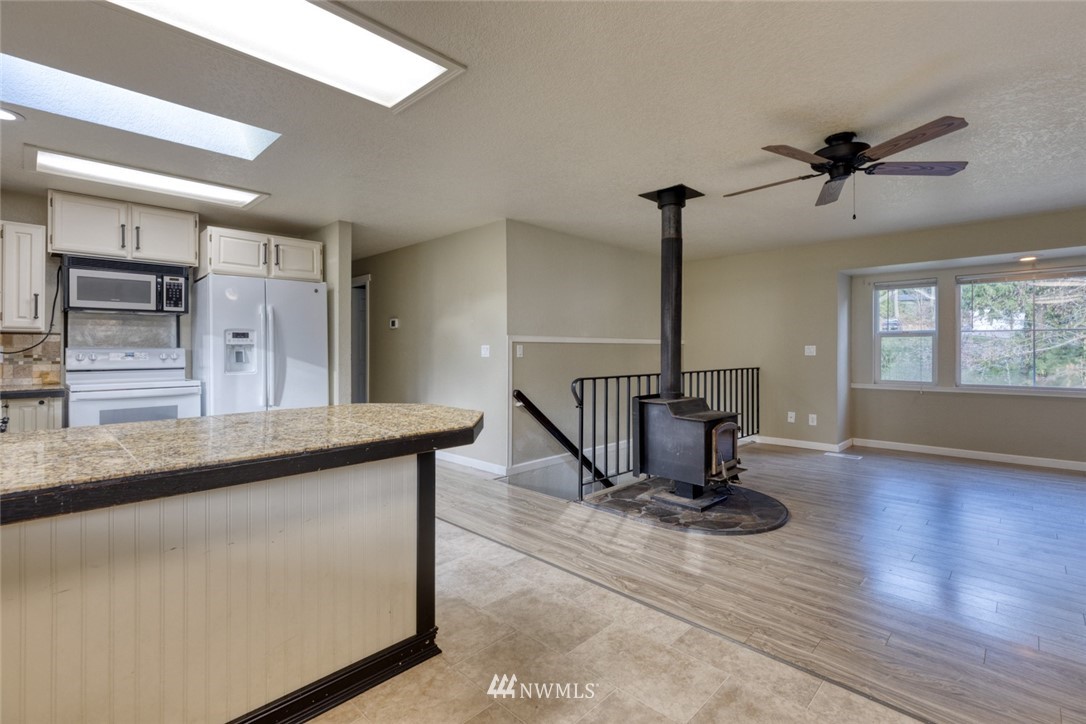 17517 48th Street East Lake Tapps, WA 98391 - Photo 7 of 36 a view of a hallway with wooden floor and staircase
