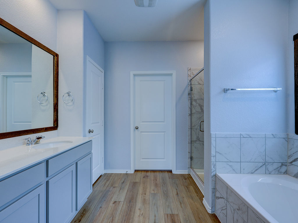 1716 Frontenac Street Leander, TX 78641 - Photo 19 of 34 a bathroom with a sink and a mirror