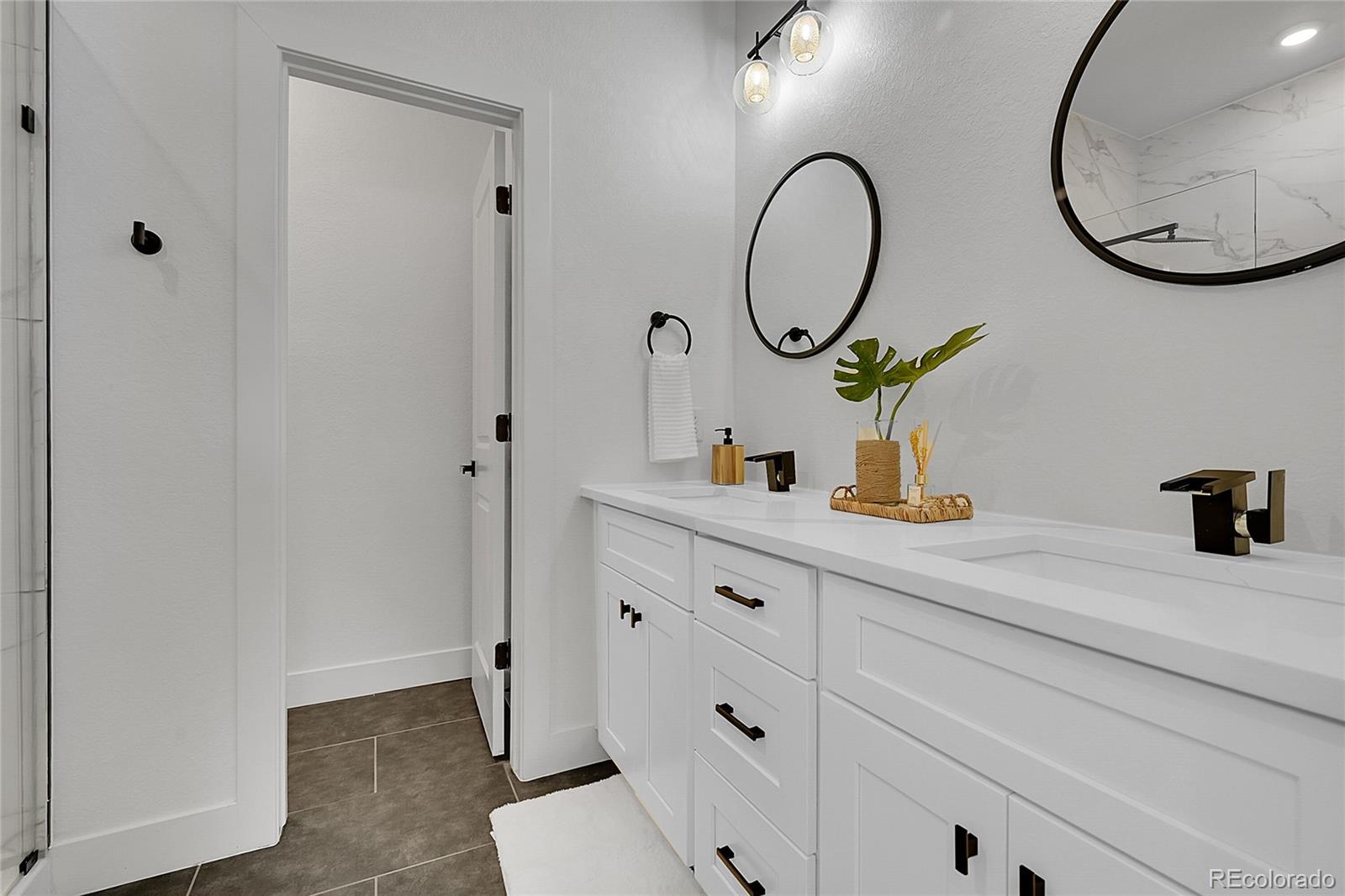 8530 West 52nd Avenue, Unit E3 Arvada, CO 80002 - Photo 13 of 27 a bathroom with a sink and a mirror
