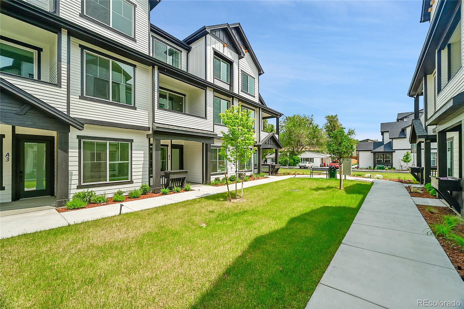 8530 West 52nd Avenue, Unit E3 Arvada, CO 80002 - Photo 2 of 27 a front view of a building with a yard