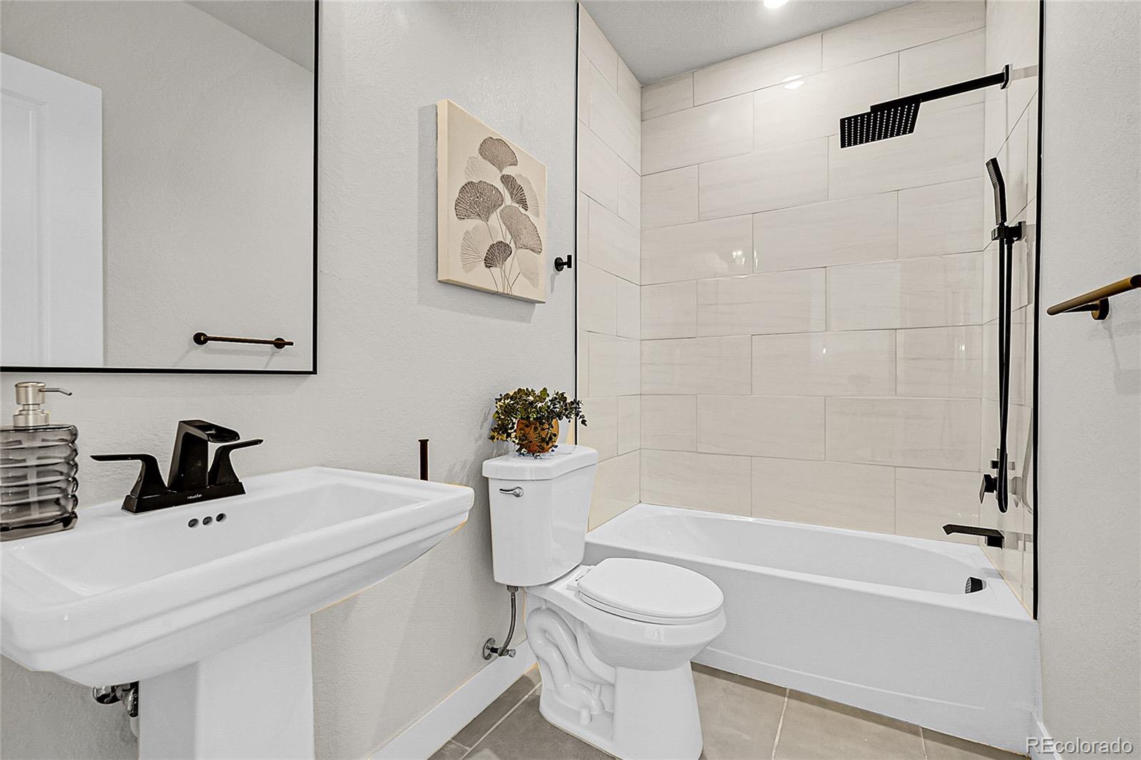 8530 West 52nd Avenue, Unit E3 Arvada, CO 80002 - Photo 8 of 27 a white toilet sitting next to a bath tub