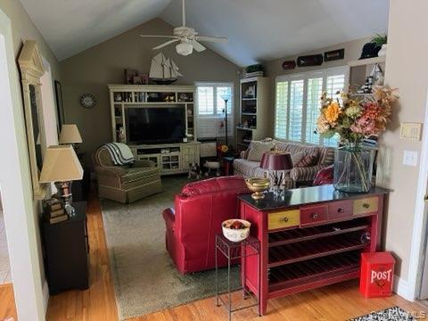 312 Riley Avenue Calverton, NY 11933 - Photo 6 of 30 Vaulted ceiling with a ceiling fan, shuttered windows, built-in entertainment center, and wood-finish flooring
