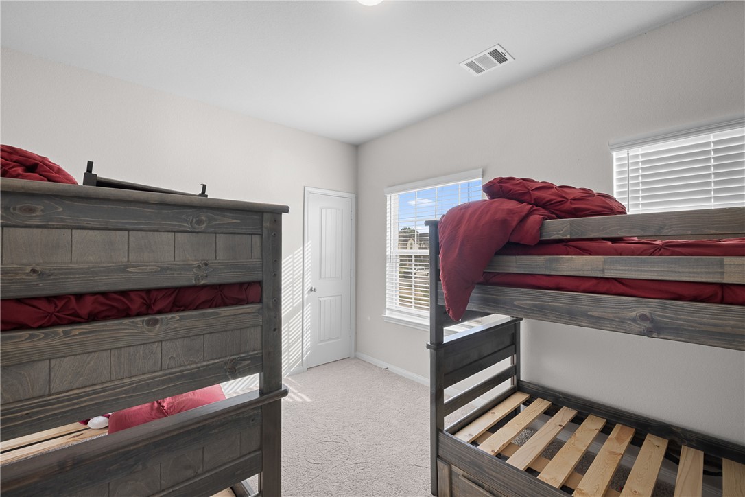 4702 Nopalitos Way Bryan, TX 77807 - Photo 19 of 27 a view of bedroom with wooden floor and closet