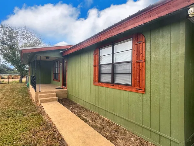 a house with swimming pool in front of it