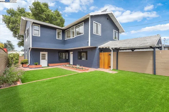 a front view of a house with a garden and yard