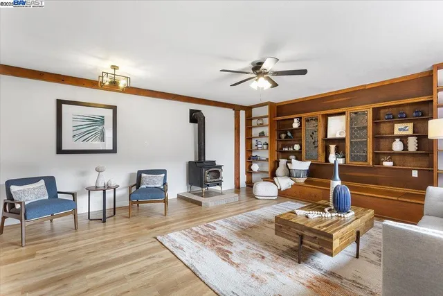 a living room with furniture a lamp wooden floor and a table