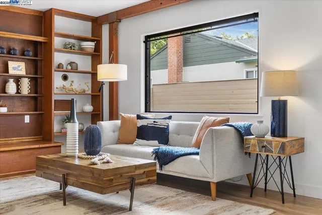 a living room with furniture and a painting on the wall