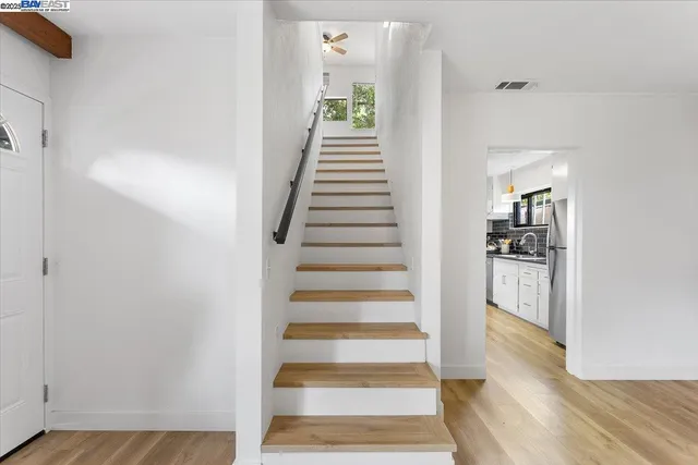 a view of an entryway with wooden floor and staircase