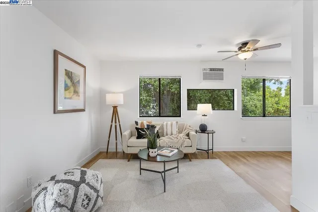a living room with furniture fireplace and a large window
