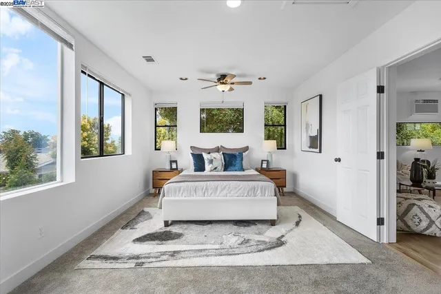 a living room with a bed furniture and a window