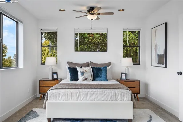 a bed sitting in a bedroom next to a window