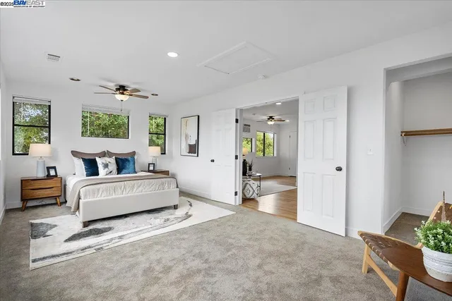 a spacious bedroom with a bed and a couch