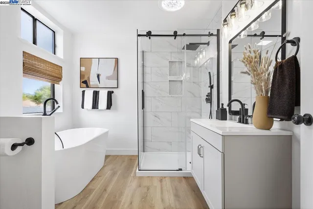 a bathroom with a shower sink and mirror