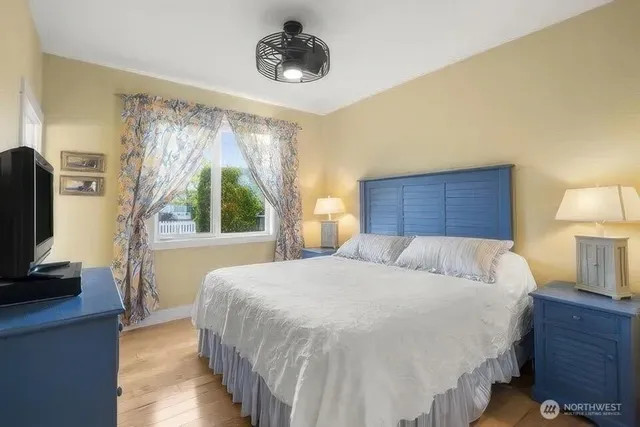 a bedroom with a large bed and a tv