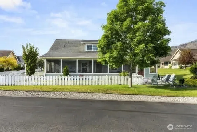 a view of a house with a swimming pool and a yard