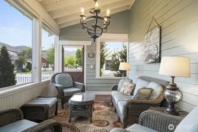 a living room with furniture a lamp and a large window