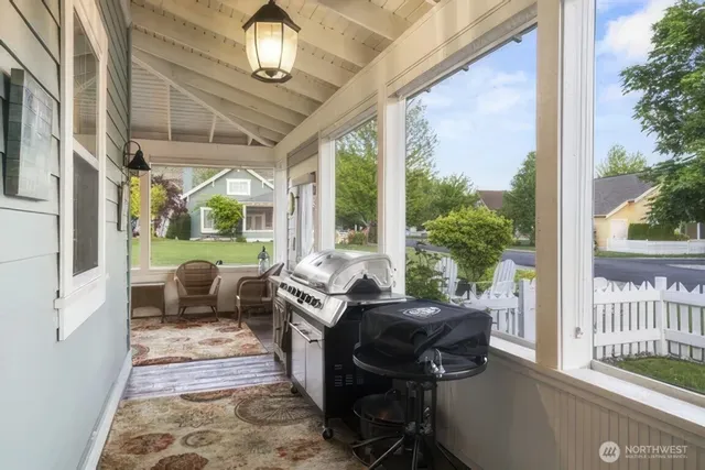 a view of a porch with furniture and a yard