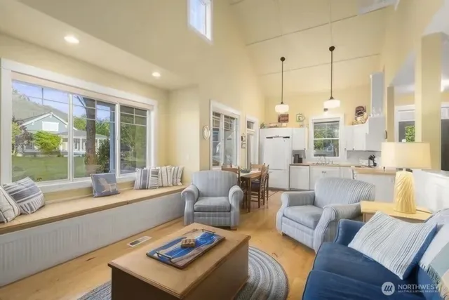 a living room with furniture and large windows