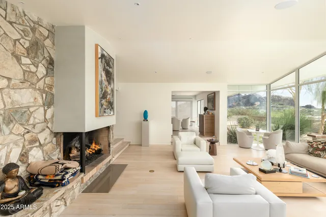 a living room with furniture and a floor to ceiling window