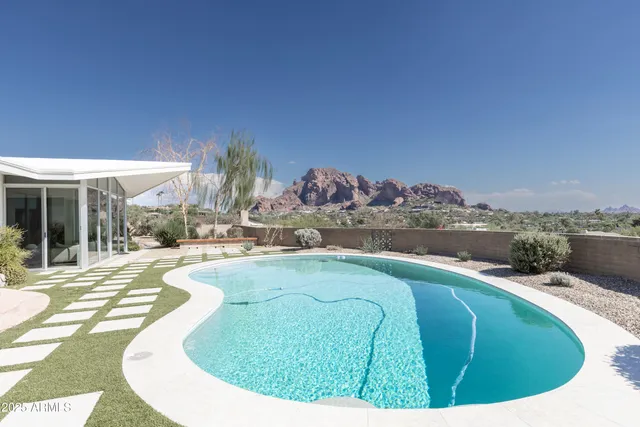 a view of a house with swimming pool and a porch