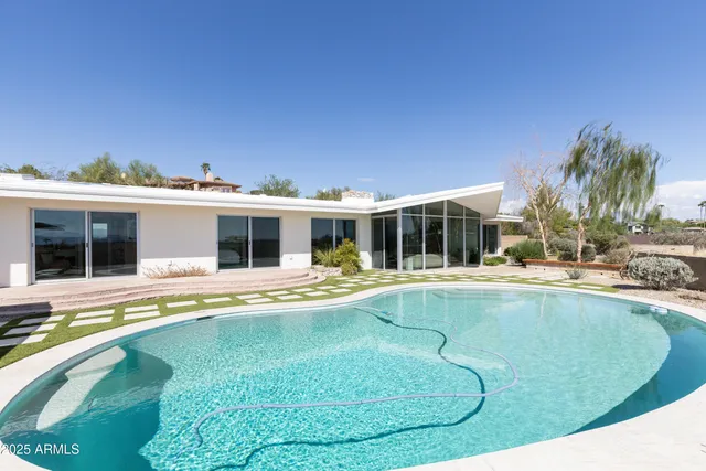 a view of a swimming pool with a lounge chair