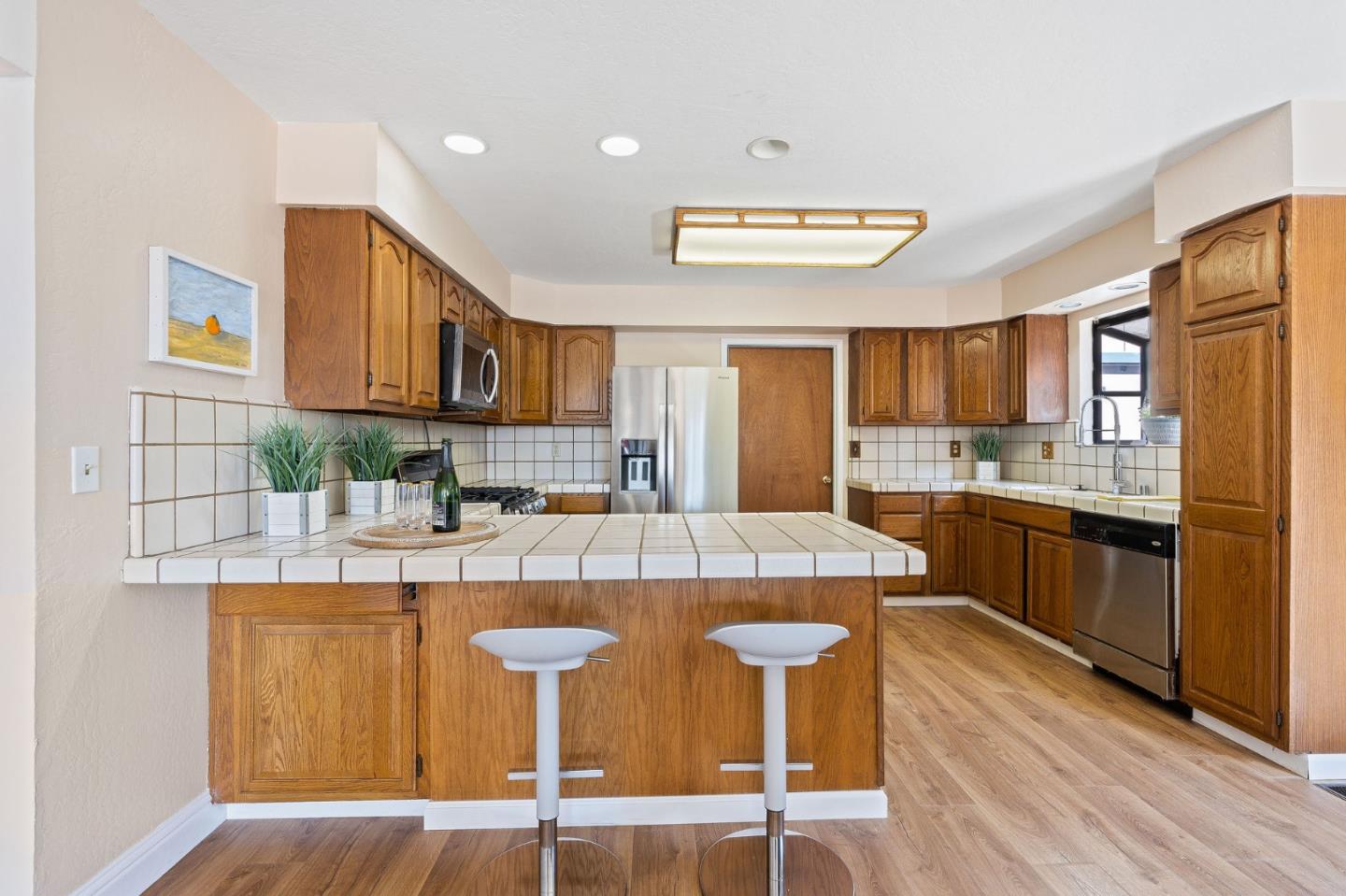 276 Hames Road Watsonville, CA 95076 - Photo 15 of 43 a kitchen with stainless steel appliances granite countertop a stove a sink dishwasher and a refrigerator with wooden floor