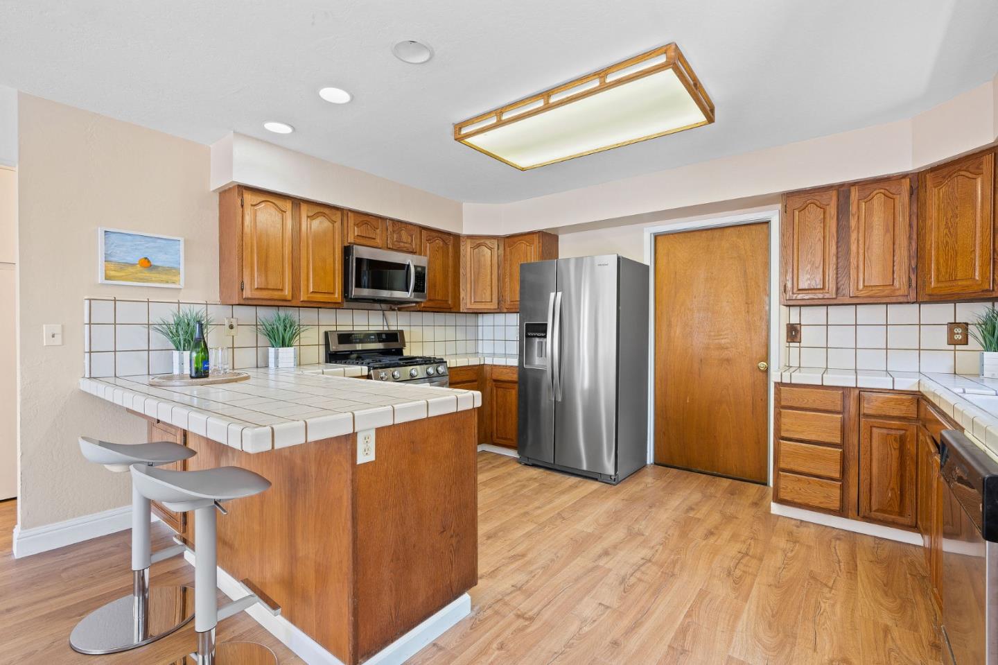 276 Hames Road Watsonville, CA 95076 - Photo 16 of 43 a kitchen with stainless steel appliances granite countertop a refrigerator stove microwave and sink