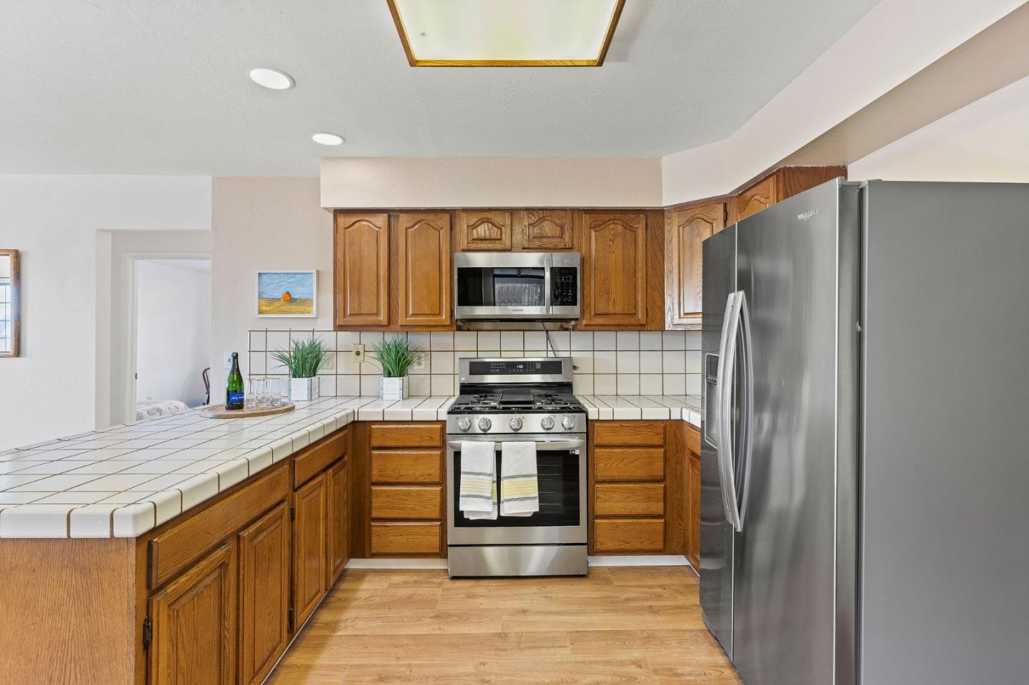 276 Hames Road Watsonville, CA 95076 - Photo 20 of 43 a kitchen with stainless steel appliances granite countertop a stove top oven a sink and a refrigerator