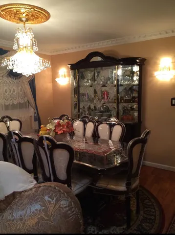 a view of a dining room with furniture and chandelier