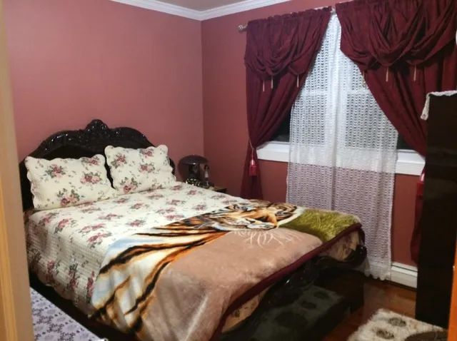 a bedroom with a bed and a potted plant