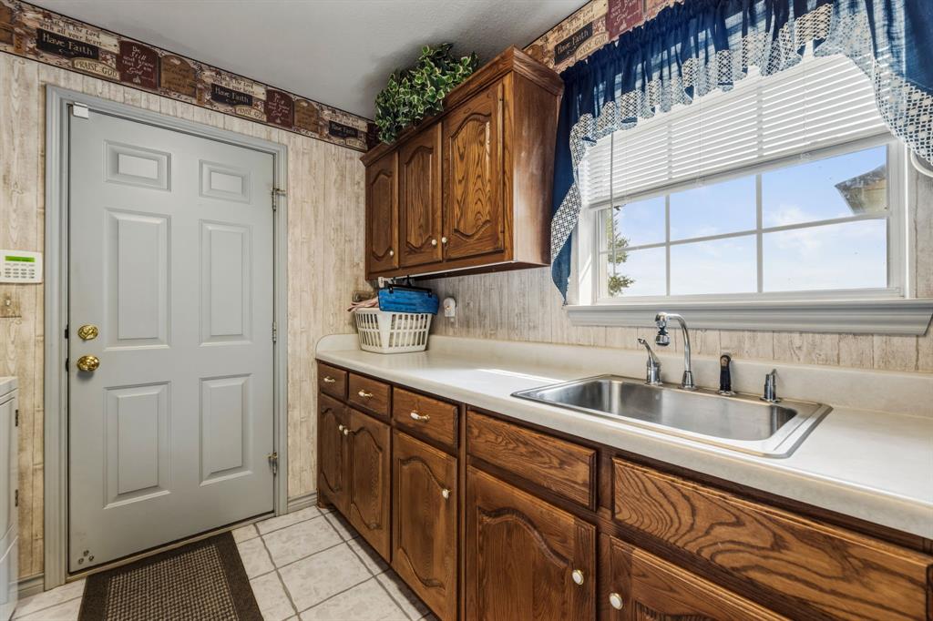 130 Blazek Road Alma, TX 75119 - Photo 24 of 34 a kitchen with a sink and cabinets