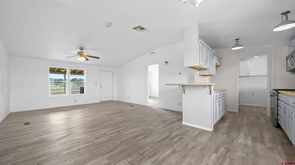 a view of kitchen with cabinets and wooden floor
