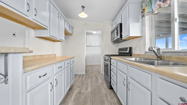 a kitchen with cabinets a sink and appliances