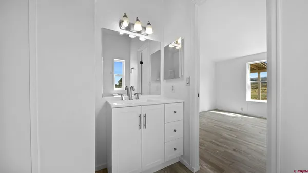 a bathroom with a double vanity sink and a mirror