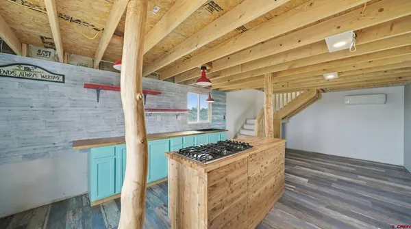 a kitchen with stainless steel appliances kitchen island wooden cabinets and a stove