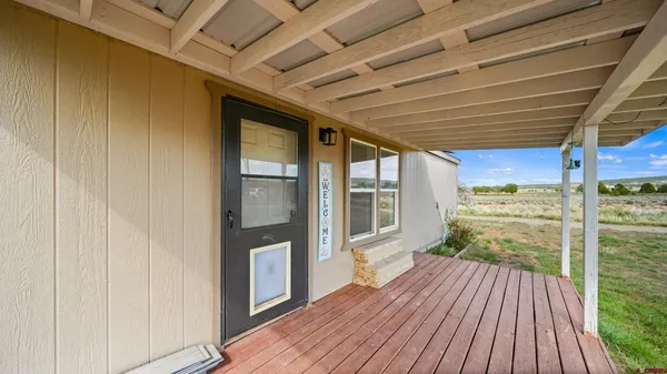a view of a porch with wooden floor and outdoor space